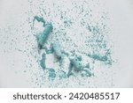Small photo of White Background With Light Blue Crushed Chalk. Small Pieces of Blue School Chalk Lying on Spilled Powder. Layout Made of Crushed Pastel Ice Blue Chalk. Flat Lay.