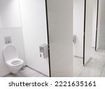 Clean white Public Washroom WC stall with white plastic toilet bowl seat inside with open lid