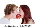 Young caucasian couple biting red apple over white background.