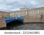Small photo of ST. PETERSBURG, RUSSIA - JULY 20, 2022: Blue Bridge, 97.3-metre-wide bridge that spans Moika River and located in front of Mariinsky Palace in Saint Petersburg. Cloudy day