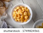 Lupins in a Bowl on a White Wooden Table with Napkins