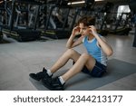 Small photo of Fitness teenage boy exercising doing crunches for abs muscles building