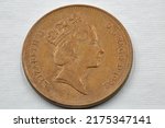 Small photo of Old used British two pence coin 1992 closeup against white. Portrait if Queen Elizabeth II.