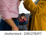 Small photo of Depressed sad child feeling in the middle of her parents fight about child custody after divorce