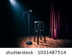 microphone and stool on a stand up comedy stage with reflectors ray, high contrast image