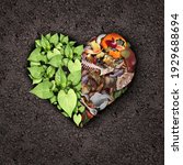 Small photo of Composting love and compost or composted soil cycle as a composting pile of rotting kitchen scraps turning into organic fertilizer for plant growth shaped into a heart as a composite.