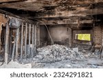 Small photo of Debris scattered in the inside of a retail storefront in Detoit after an arsonist burned the building.