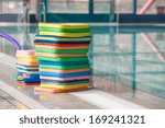 Stack of the colourful swim boards in the swimming pool.