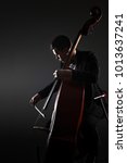 Small photo of Double bass player contrabass playing. Classical musician orchestra bassist.