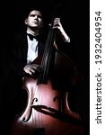 Small photo of Double bass player contrabass playing. Jazz musician bassist