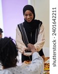 Small photo of In a heartwarming scene during the sacred month of Ramadan, a traditional Muslim woman offers dates to her family gathered around the table, exemplifying the spirit of unity, generosity, and cultural