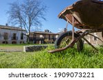 Small photo of Old rusty handbarrow reused as a planter, Granadilla, Extremadur