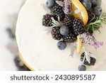 closeup of berries lemon rosemary cake garnish