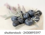 closeup of blueberry, rosemary, and lavender garnish