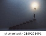 Creative and idea concept with man in suit back view on the top of stairway turning on big light bulb on dark concrete background