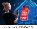 Small photo of Online casino and gaming, gambling on device concept. Back view of blonde european woman and smartphone with creative slot machine and other games