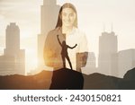 Small photo of A professional looking woman in business attire superimposed over a city skyline during sunrise or sunset