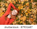 Woman Lying On Autumn Leaves ...