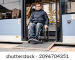 Small photo of Person with a physical disability exits public transport with an accessible ramp.