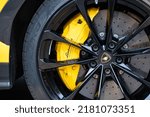 Small photo of Munich, Bavaria, Germany - July 21 2022: The stylish mag wheel and brake caliper of an Italian legend, the Lamborghini sports car. The car is yellow in color and it matches the calipers.