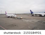 Small photo of Almaty, Kazakhstan - 03.16.2022 : The plane of the Mongolian airline Hunnu Air is parked at the airport site.