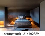 Small photo of Bedroom with double bed and pillows. To the left of the bed is the bathtub. Romantic and intimate scene. The walls are gray. Nobody inside