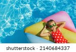 Small photo of Child in swimming pool. Having fun on vacation at the hotel pool. Colorful vacation concept.