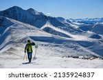 Skier standing on the top of Peak 8 at the Breckenridge Ski Resort in Colorado. Active lifestyle, extreme winter sports.