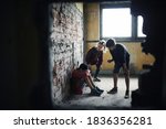Small photo of Teenage boy attacked by thugs in abandoned building, gang violence and bullying concept.