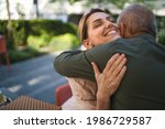 Woman Hugging Senior Father...