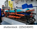 Small photo of Close-up of empty stretcher inside ambulance vehicle.