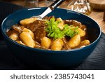 Beef stew in gravy, served with potato dumplings.