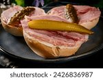 Small photo of Tasty sandwich with brawn and pickled cucumber. Dark light. Shallow depth of field.