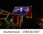 Small photo of Sochi, Russia-20.09.2018 The President of the Russian Federation Vladimir Putin. Two young men in Christmas hats. New year. An appeal to the country. Congratulations to the President.