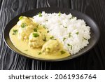 Small photo of Pork Meatballs in Curry Boller i Karry close up in the plate on the table. horizontal