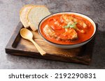 Small photo of Fish tomato soup with carp steak, vegetables and paprika close-up in a bowl on the table. Horizontal