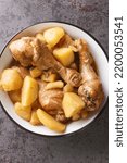 Small photo of Semur Ayam Kentang Kecap Chicken Potatoes Smoor closeup on the bowl on the table. Vertical top view from above