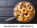Assorted shortbread cookie close-up on a plate on a table. vertical view from above