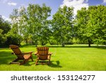 Two Wooden Adirondack Chairs On ...