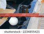 Small photo of Sailing in Split, Croatia. Sailing yacht wooden boarding gangplank walking bridge (passerelle) mounted to the stern of the boat in a marina.