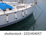 Small photo of Sailing in Sardinia, Italy. Sailing yacht fenders on starboard side. Inflatable fender buoys.