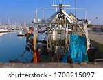Fishing boat and fishing net seen from behind in the port of Saint-Vaast-la-Hougue, a commune in the peninsula of Cotentin in the Manche department in Lower Normandy in north-western France