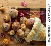 Small photo of Buns and rolls spilling out of a homemade cornucopia made of bread.