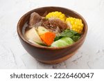 Small photo of Photo of freshly cooked Filipino food called Beef Bulalo or beef bone marrow with mixed vegetables in beef broth.