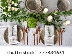 Holiday table setting with Linen napkins and rose gold cutlery. Close up