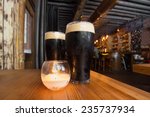 Dark beer and candle in pub setting