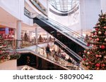 Multilevel shopping mall interior decorated with christmas trees