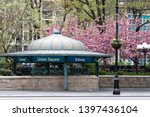 New York City subway station entrance in Union Square Park with colorful spring flowers