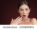Beauty portrait of a topless attractive shocked woman isolated over background, looking at camera