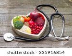Healthy food in heart and cholesterol diet concept on vintage boards